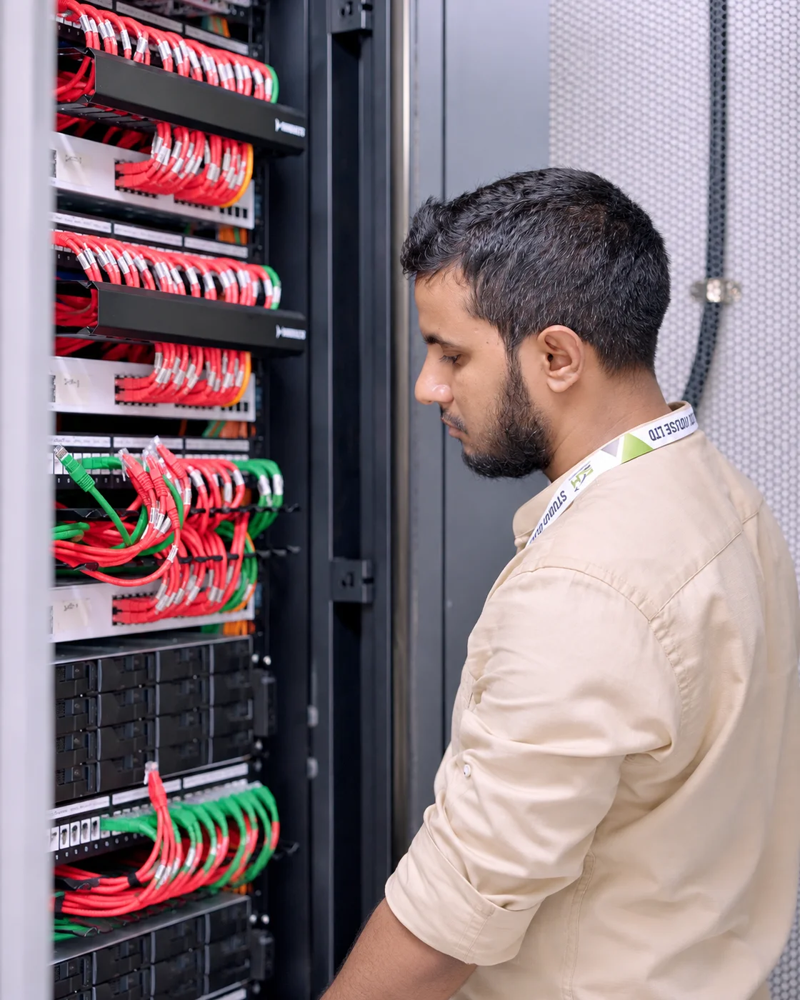 IT specialist inspecting network server rack and data infrastructure at Studio Click House Dhaka