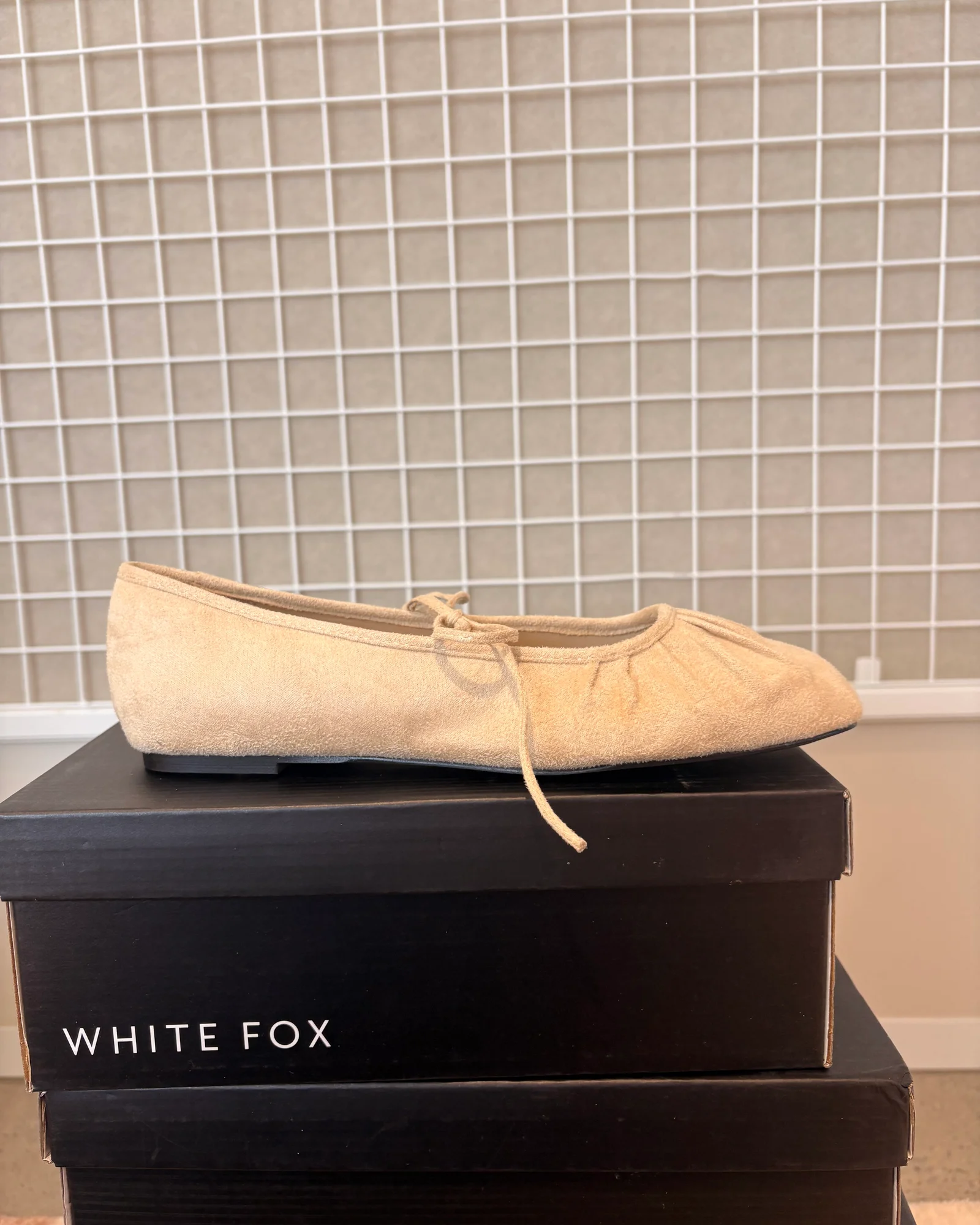 Beige suede ballet flat footwear studio capture before retouching and prop removal