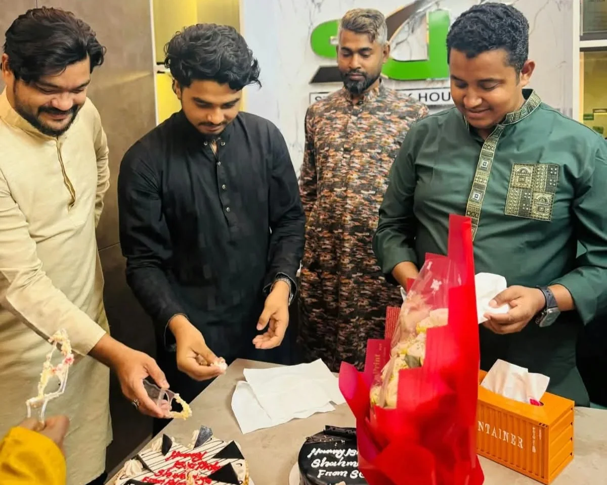Studio Click House team members gathered together celebrating a birthday at the studio