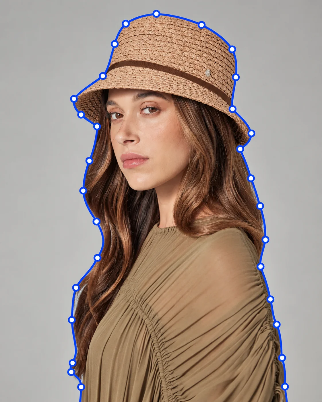 Fashion model wearing a straw hat outlined with a clipping path