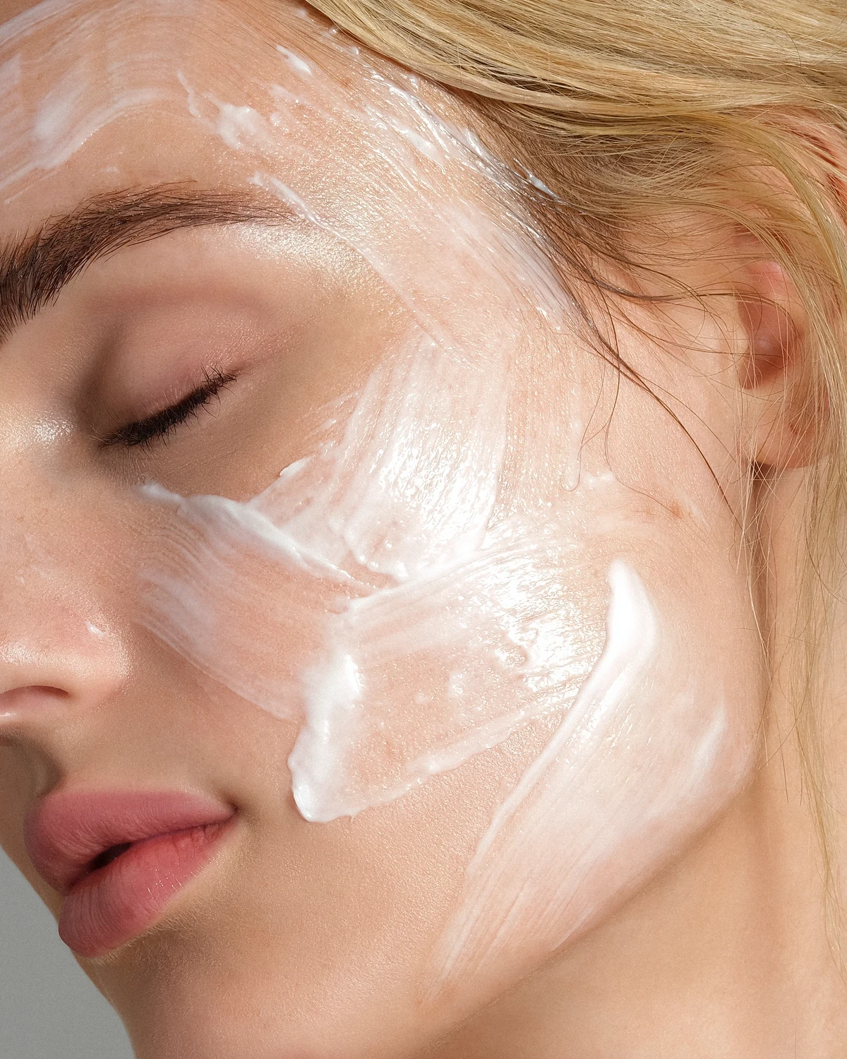 Close-up skincare campaign portrait with cream applied to the face