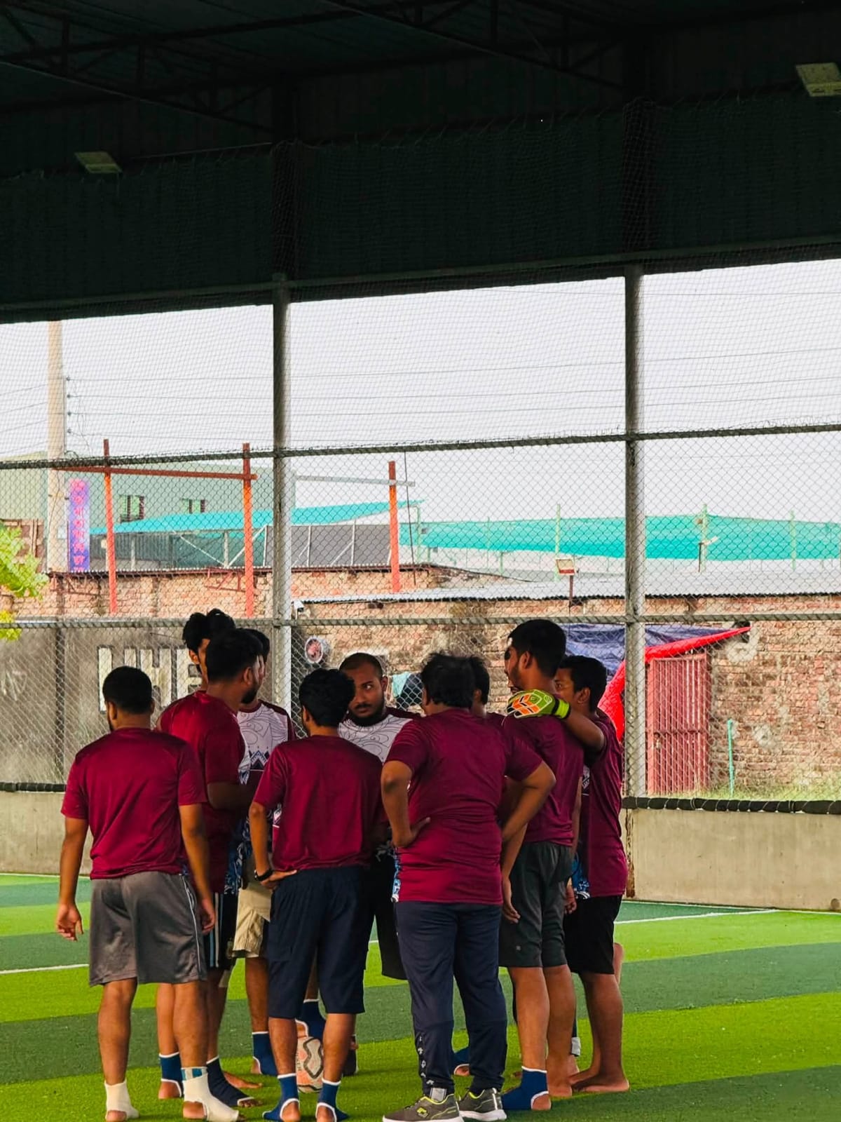 Studio Click House teammates celebrating a goal on the turf