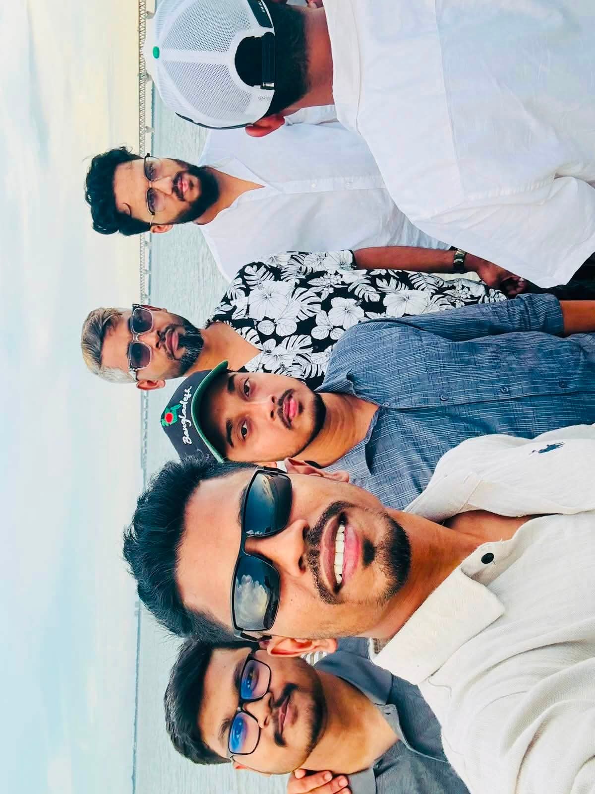 Studio Click House colleagues laughing by the riverside at Mawa