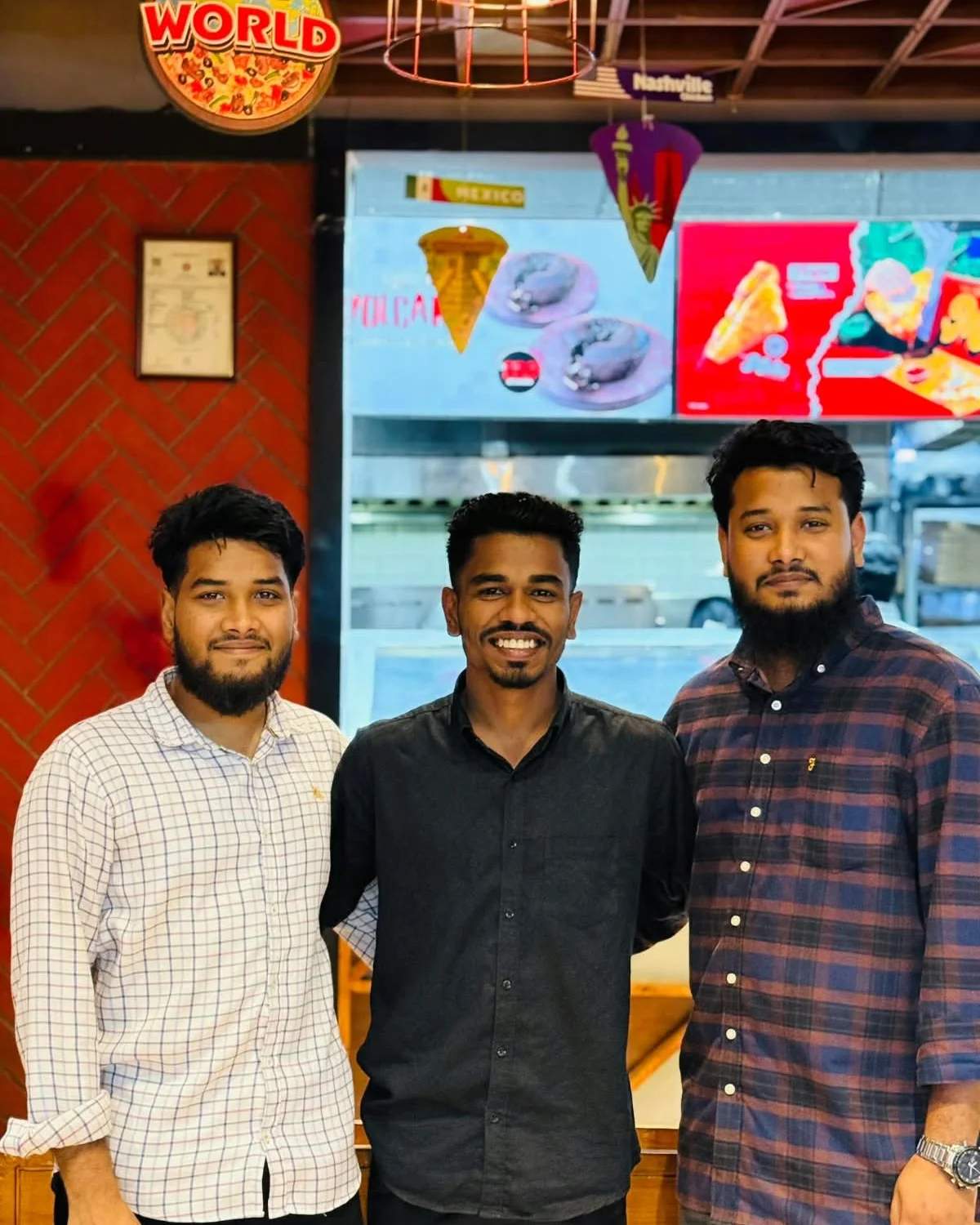 Studio Click House team members posing together at pizza celebration
