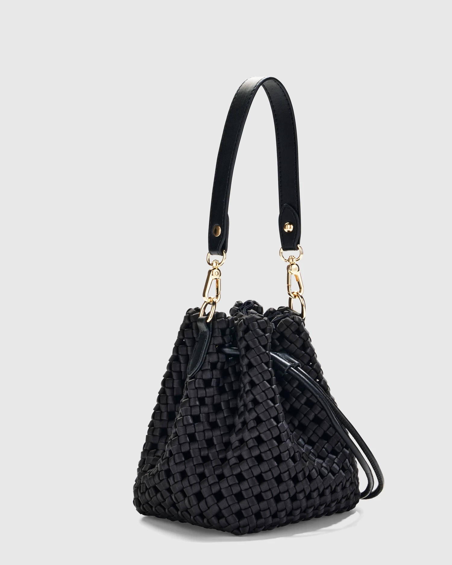 Black quilted leather handbag with gold hardware on a light background